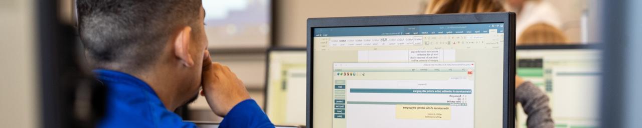 Health Information Management student working on a computer